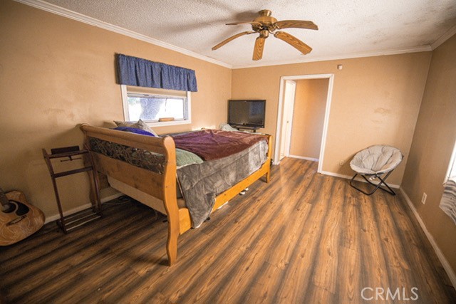 6701 Gaylord Street Riverside, CA 92505 - Photo 11 of 25 a bedroom with a bed and wooden floor
