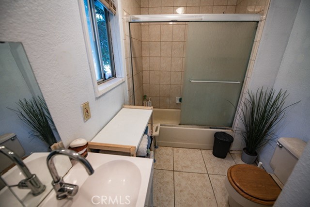 6701 Gaylord Street Riverside, CA 92505 - Photo 15 of 25 a bathroom with a sink a toilet and a mirror