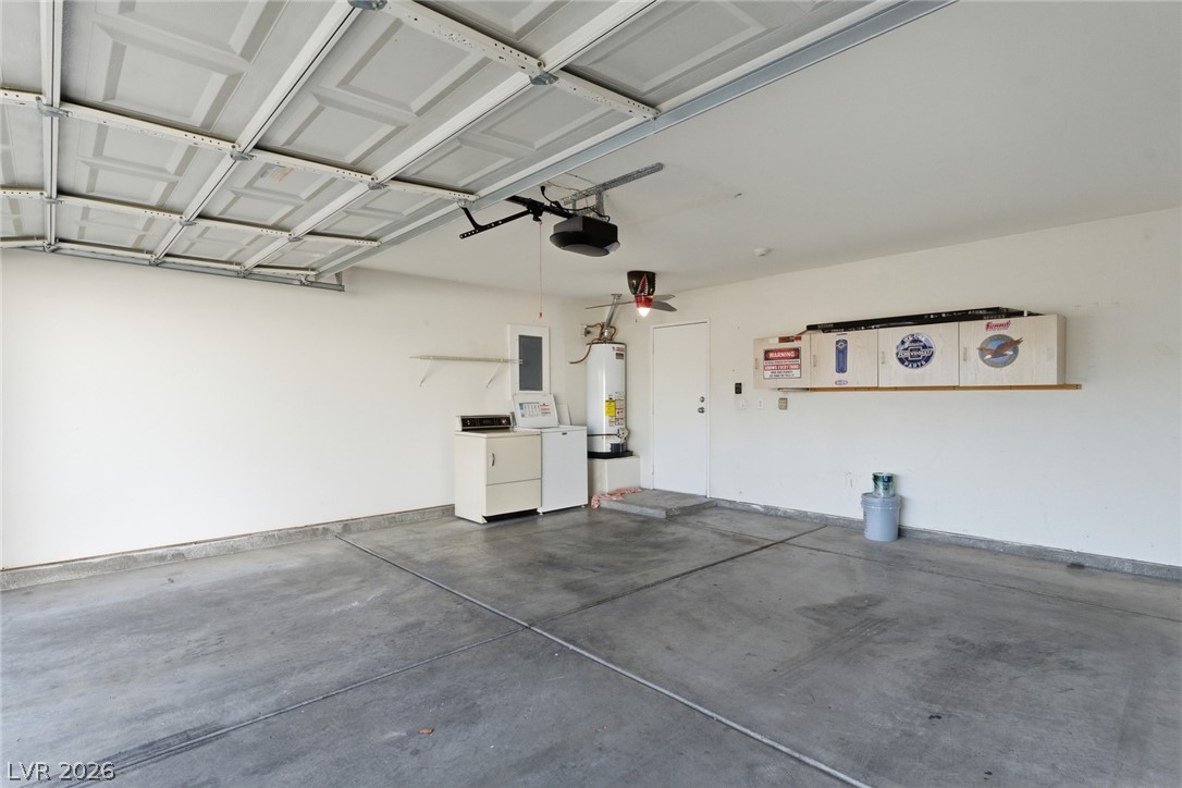 5449 Bugle Way, Unit 104 Las Vegas, NV 89108 - Photo 31 of 33 This spacious garage offers ample room and functional features, perfect for storage and utility needs.