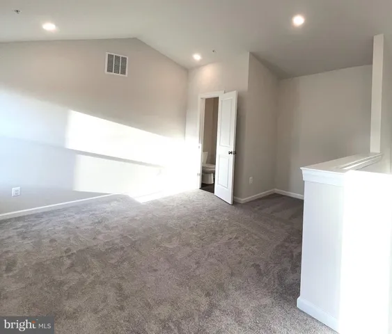 a view of an empty room and a window