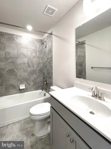 a bathroom with a shower sink and mirror