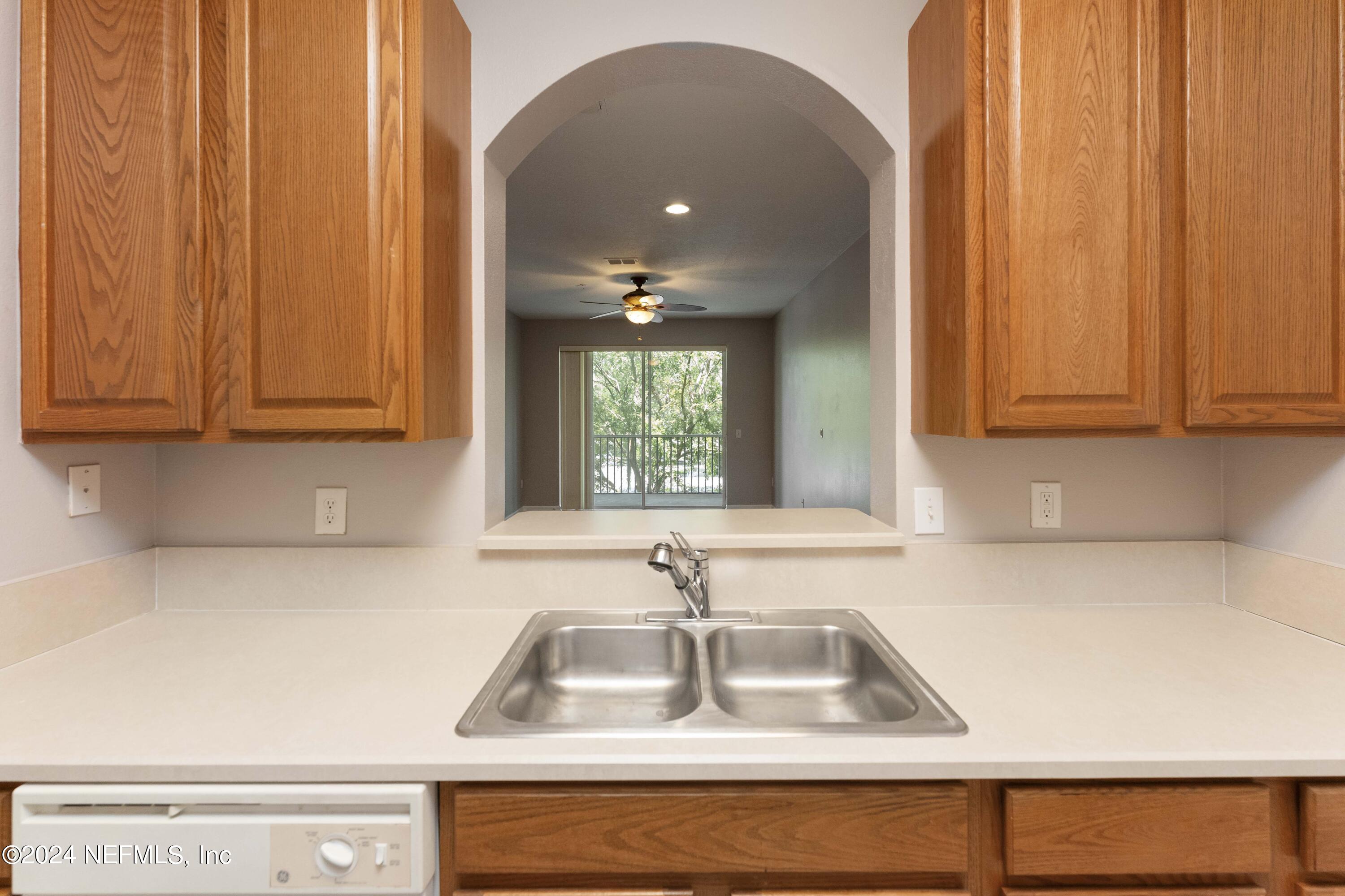 7801 Point Meadows Drive, Unit 5202 Jacksonville, FL 32256 - Photo 13 of 34 a kitchen with a sink cabinets and a window