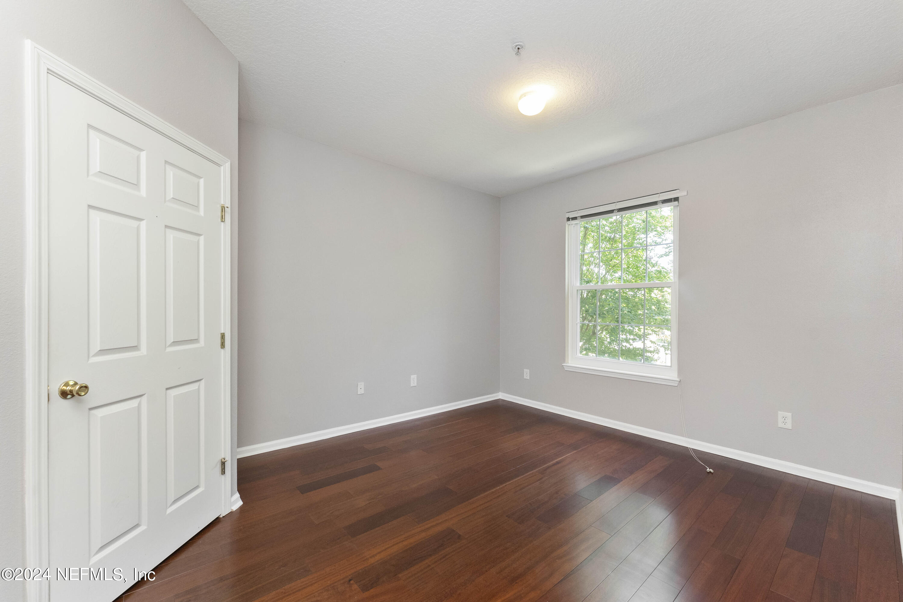 7801 Point Meadows Drive, Unit 5202 Jacksonville, FL 32256 - Photo 15 of 34 an empty room with wooden floor and windows