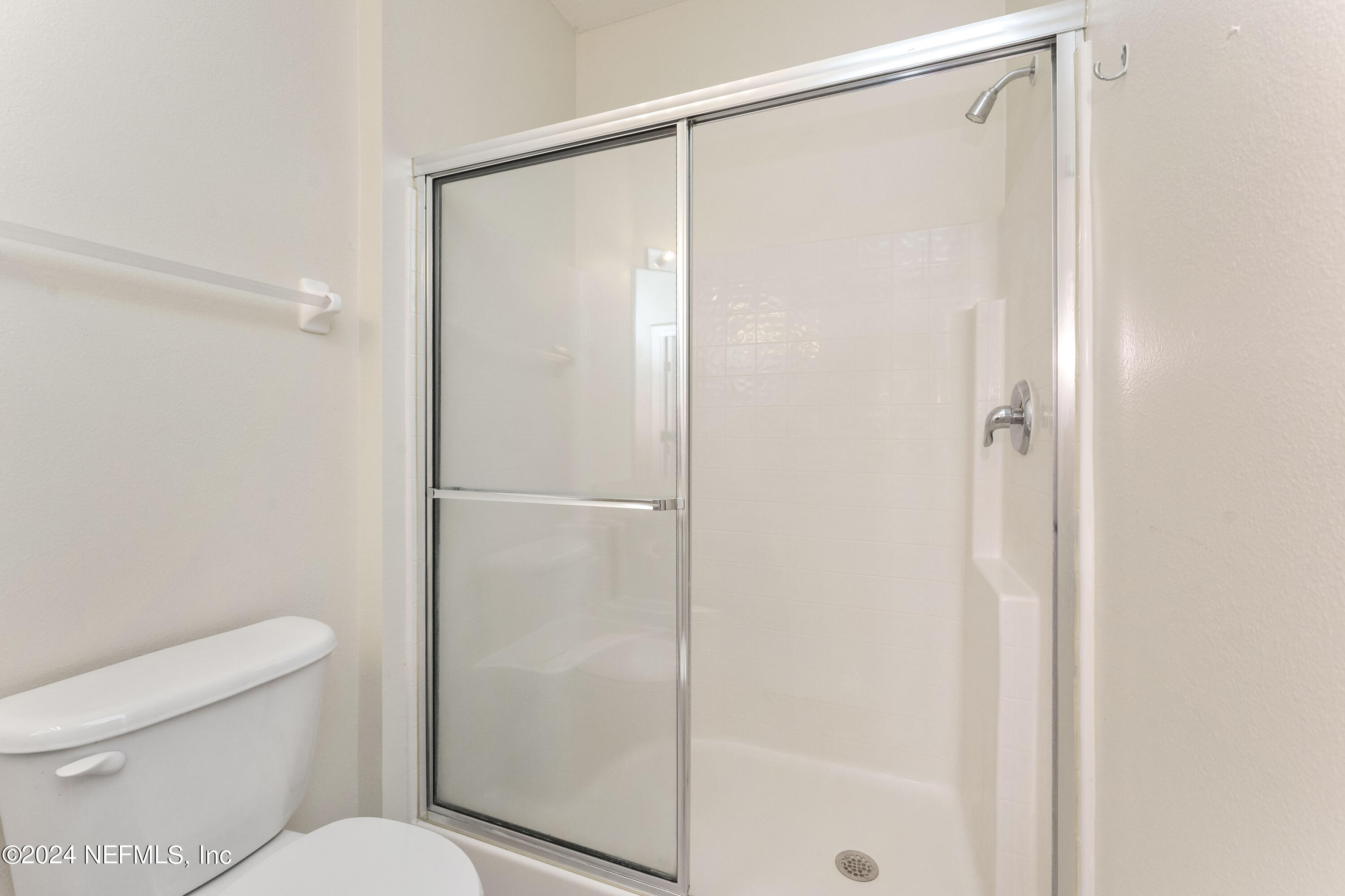7801 Point Meadows Drive, Unit 5202 Jacksonville, FL 32256 - Photo 18 of 34 a bathroom with a shower a toilet and a shower
