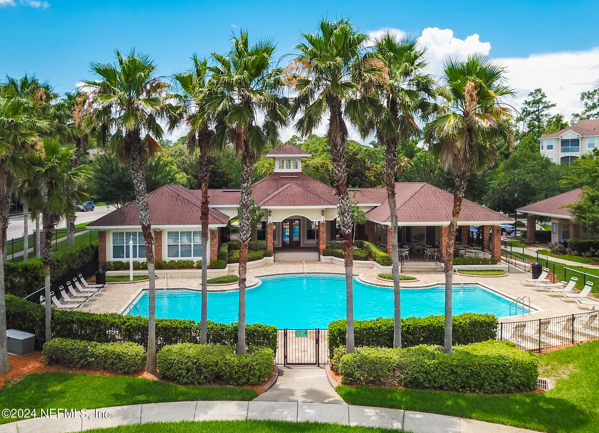 7801 Point Meadows Drive, Unit 5202 Jacksonville, FL 32256 - Photo 32 of 34 a view of pool with table and chairs under an umbrella