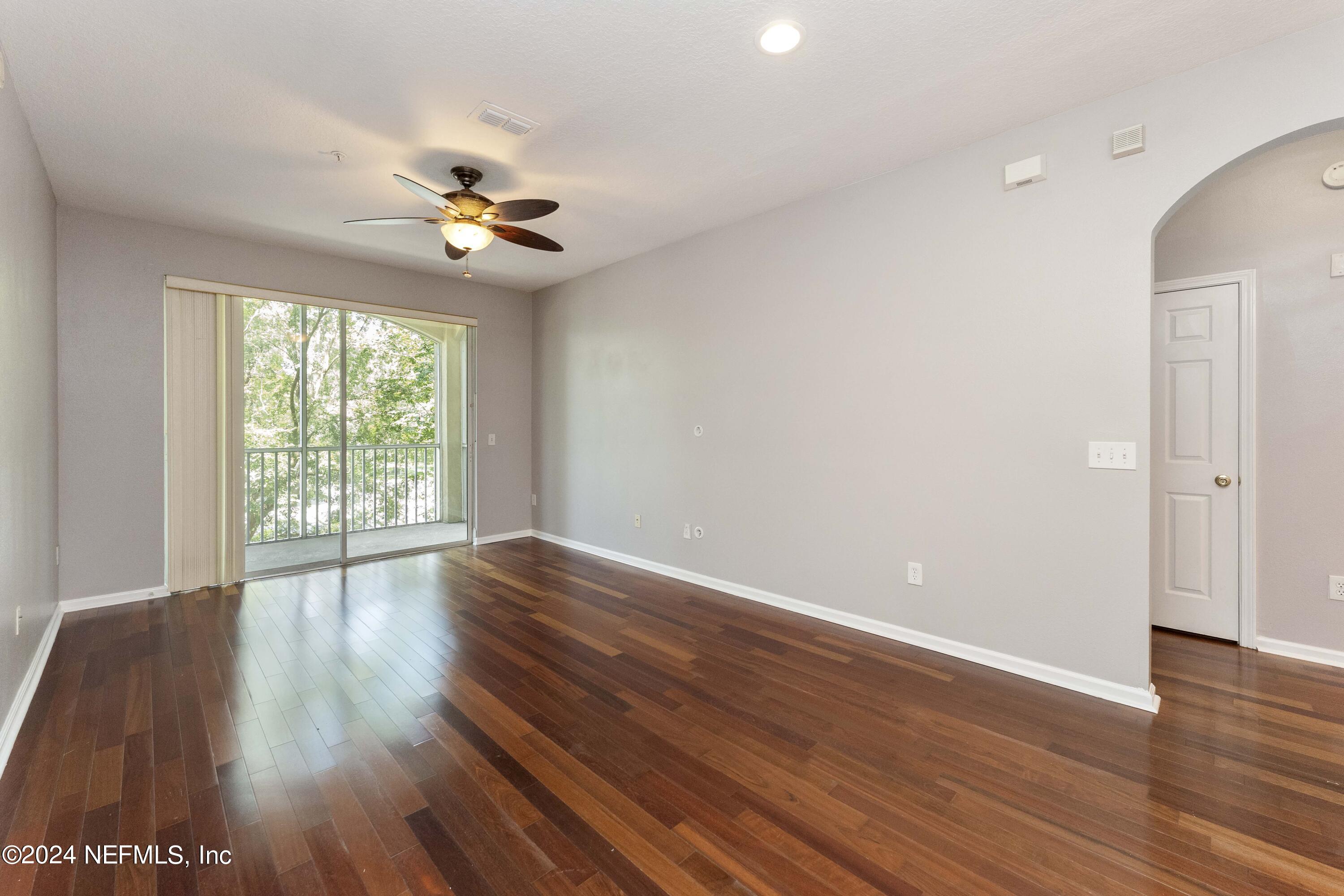 7801 Point Meadows Drive, Unit 5202 Jacksonville, FL 32256 - Photo 9 of 34 wooden floor in an empty room with a window