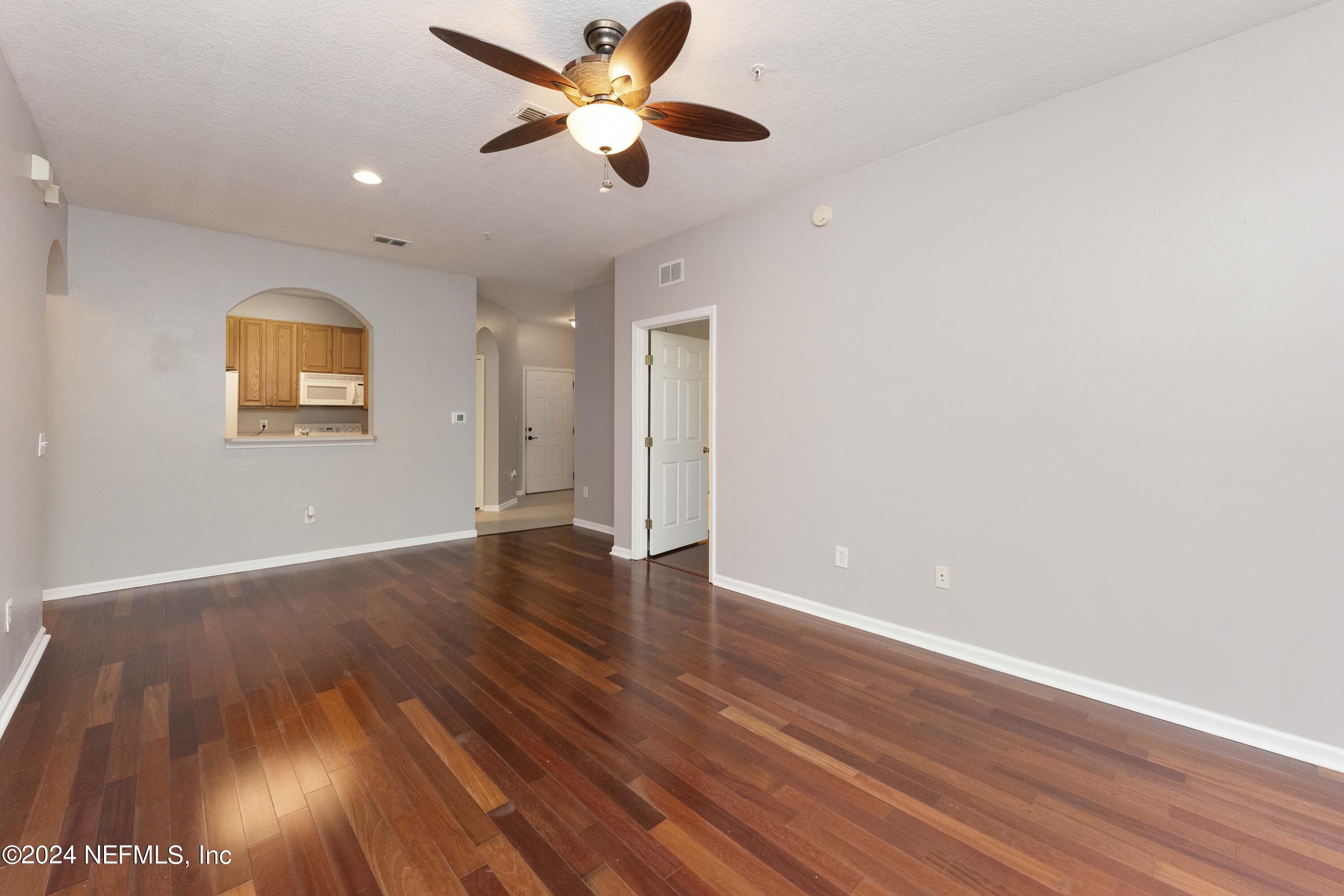 7801 Point Meadows Drive, Unit 5202 Jacksonville, FL 32256 - Photo 10 of 34 a view of an empty room with window and wooden floor
