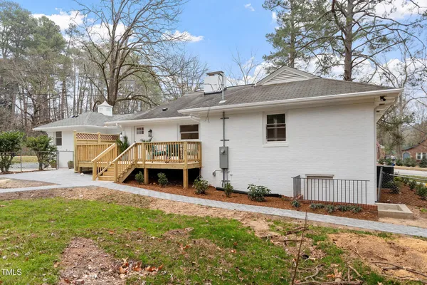 a view of a house with a yard and furniture