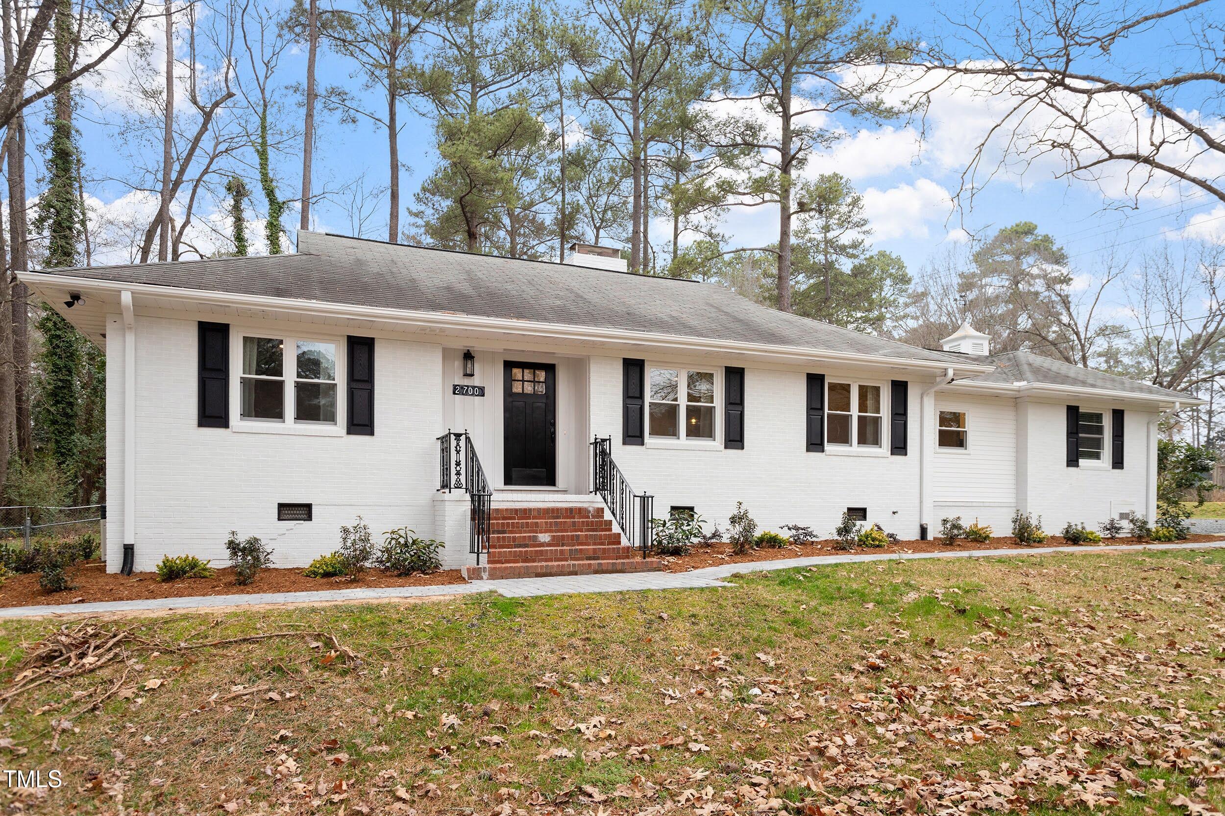 2700 University Drive, Unit B Durham, NC 27707 - Photo 2 of 17 a view of a white house with a yard