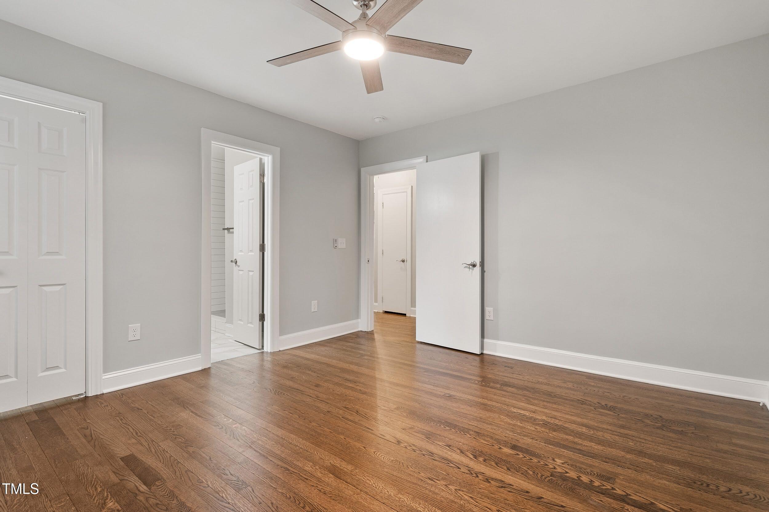 2700 University Drive, Unit B Durham, NC 27707 - Photo 8 of 17 an empty room with wooden floor and windows
