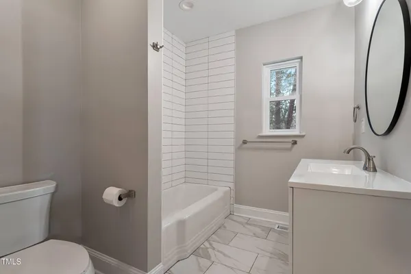 a bathroom with a sink toilet and tub