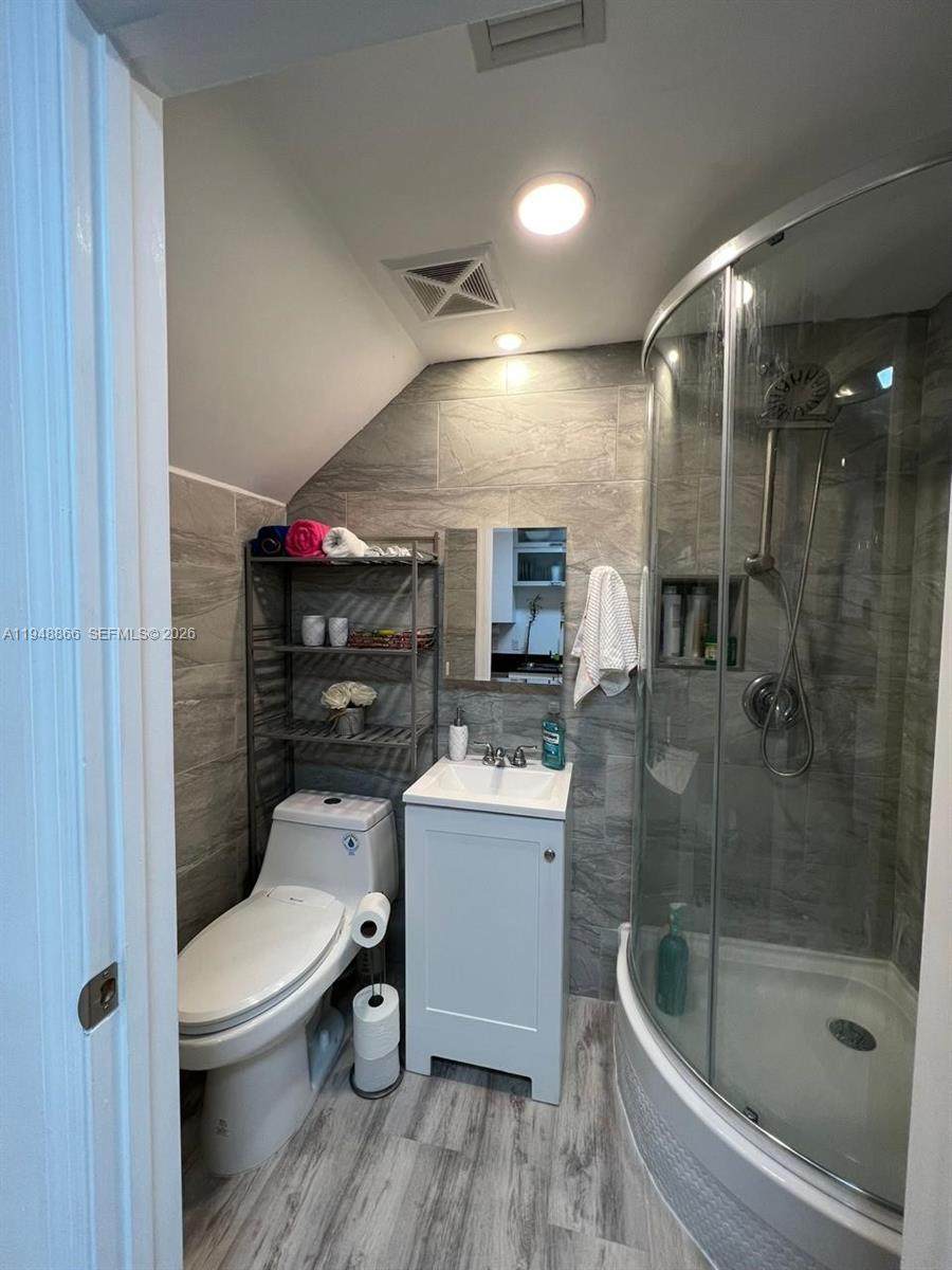 60 Southwest 13th Street, Unit 3013 Miami, FL 33130 - Photo 11 of 26 a bathroom with a toilet a sink and shower