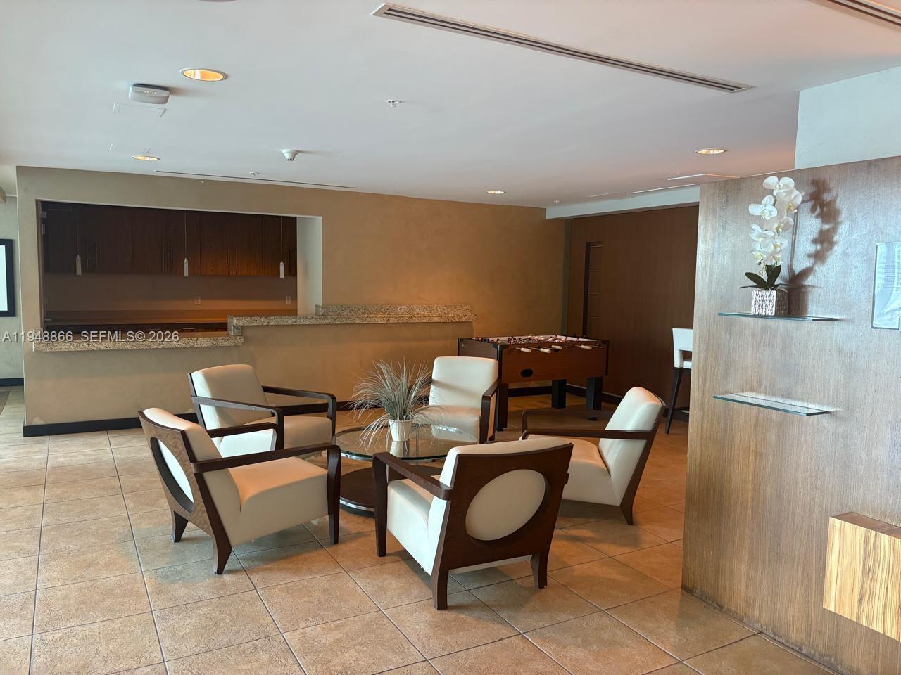 60 Southwest 13th Street, Unit 3013 Miami, FL 33130 - Photo 17 of 26 a living room with furniture and a flat screen tv