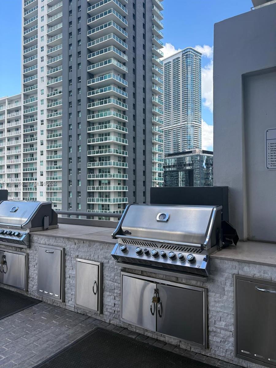 60 Southwest 13th Street, Unit 3013 Miami, FL 33130 - Photo 22 of 26 a stove top oven sitting inside of a kitchen