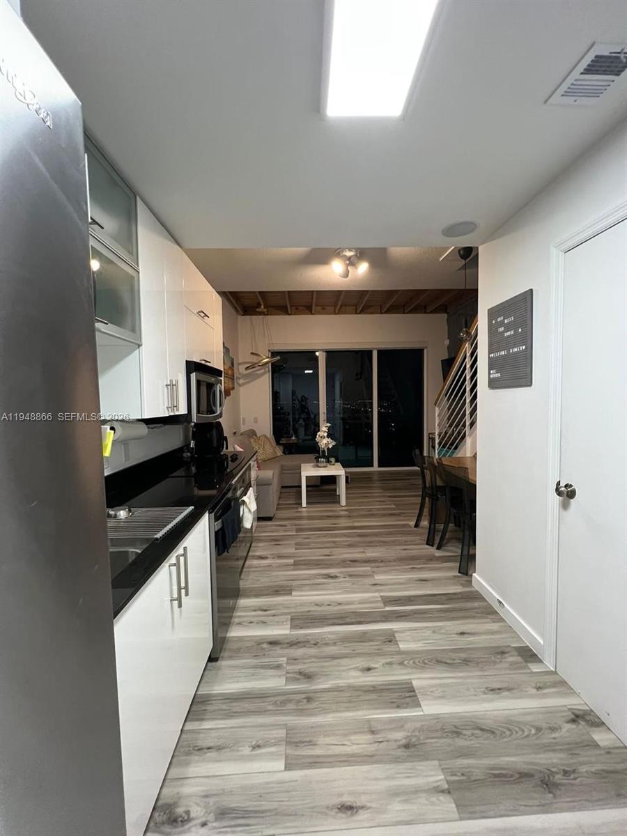 60 Southwest 13th Street, Unit 3013 Miami, FL 33130 - Photo 7 of 26 a view of a living room kitchen and a sink