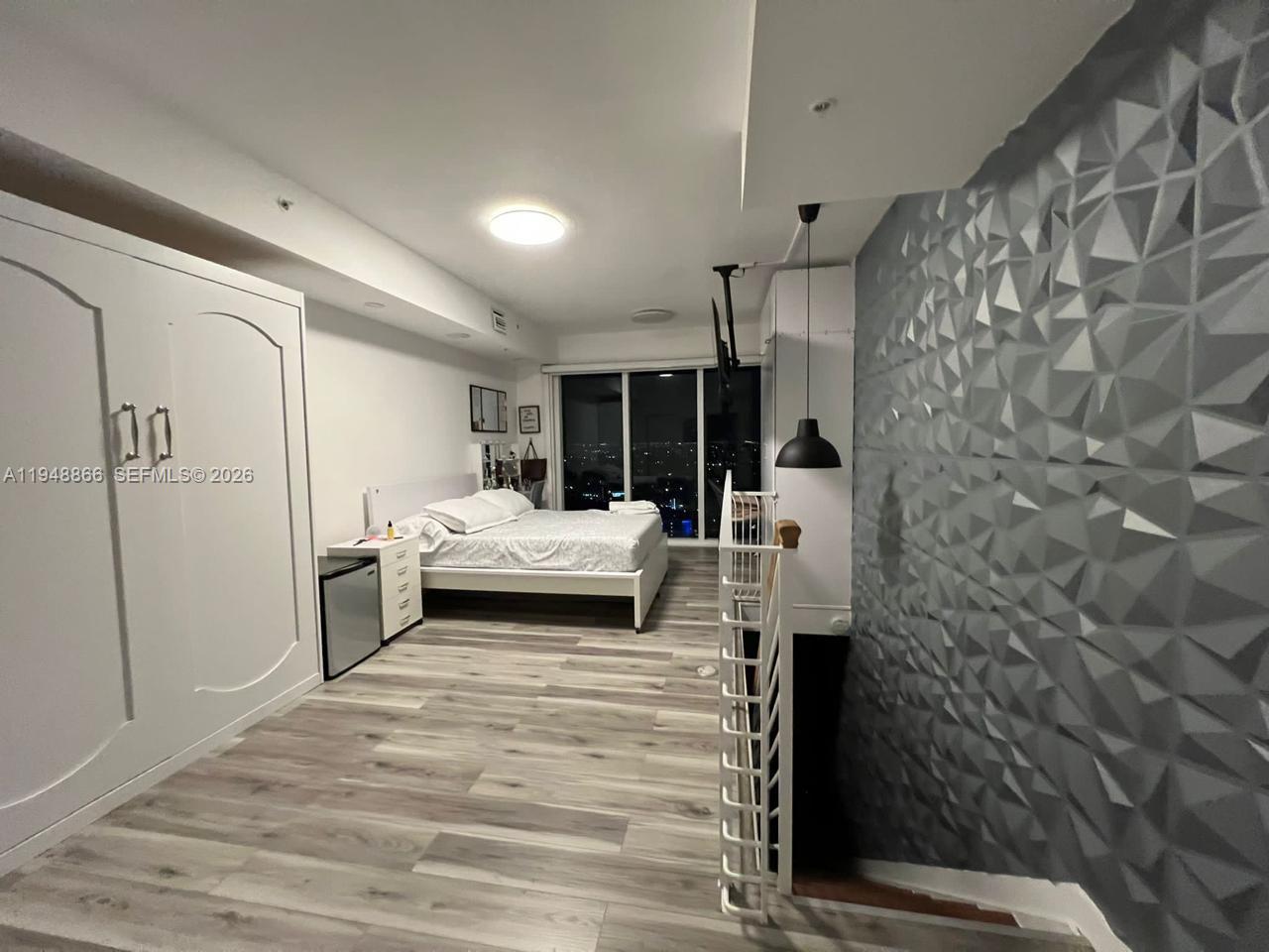 60 Southwest 13th Street, Unit 3013 Miami, FL 33130 - Photo 9 of 26 a bedroom with a bed and a mirror