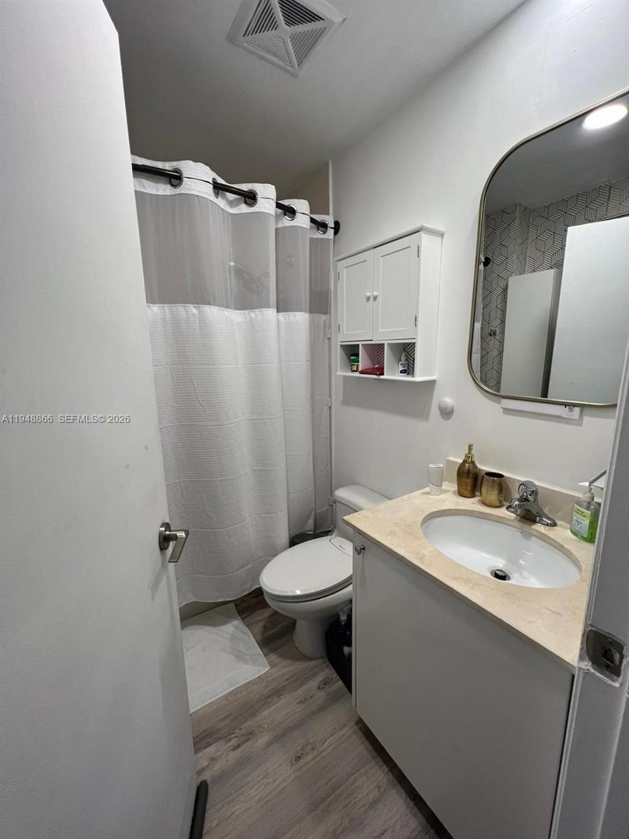 60 Southwest 13th Street, Unit 3013 Miami, FL 33130 - Photo 10 of 26 a bathroom with a sink toilet and shower