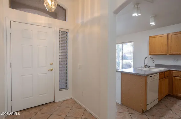 a kitchen with a sink cabinets and a window