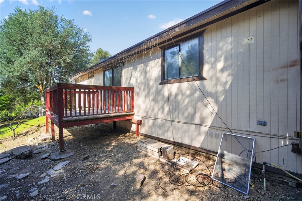 3804 Owl Creek Road Mariposa, CA 95338 - Photo 4 of 18 a view of a backyard with a small deck and a garden