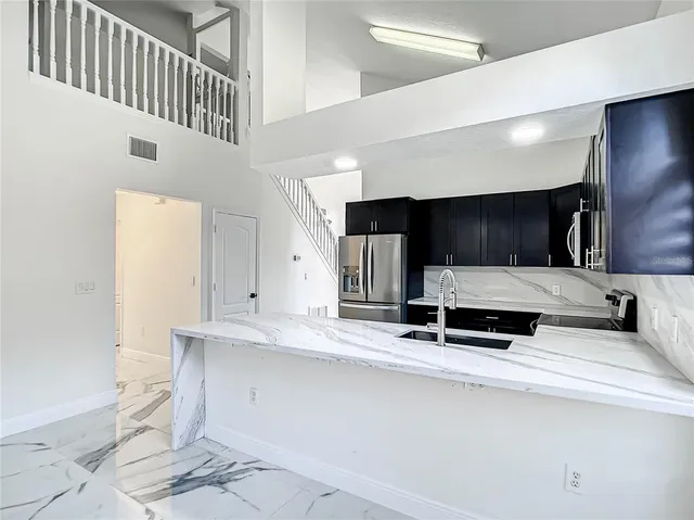 a view of a chandelier fan and windows