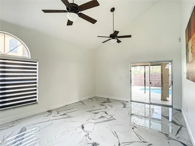 a view of a room with window and ceiling fan