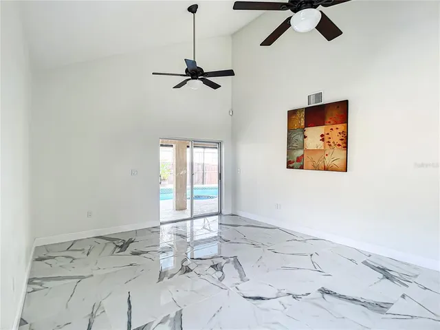 a view of a hallway with wooden floor and chandelier
