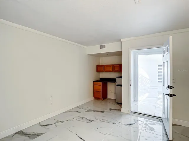 a view of a room with wooden floor and bathroom