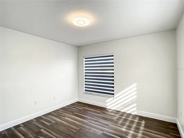 a bathroom with a sink a toilet a glass door shower and a mirror