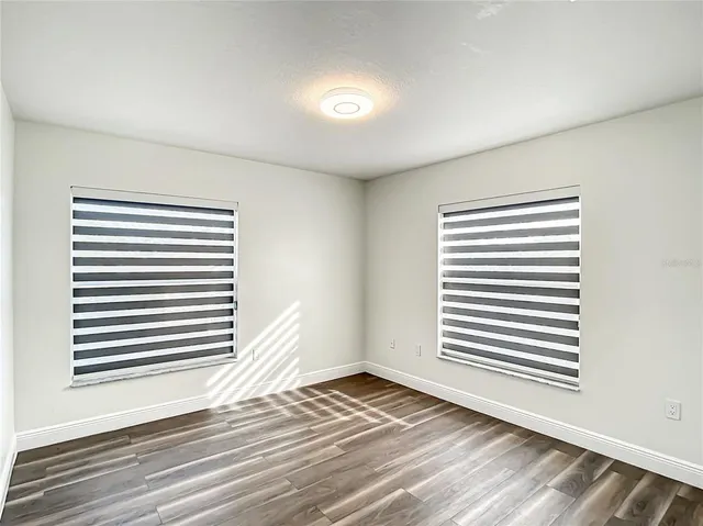 an empty room with wooden floor