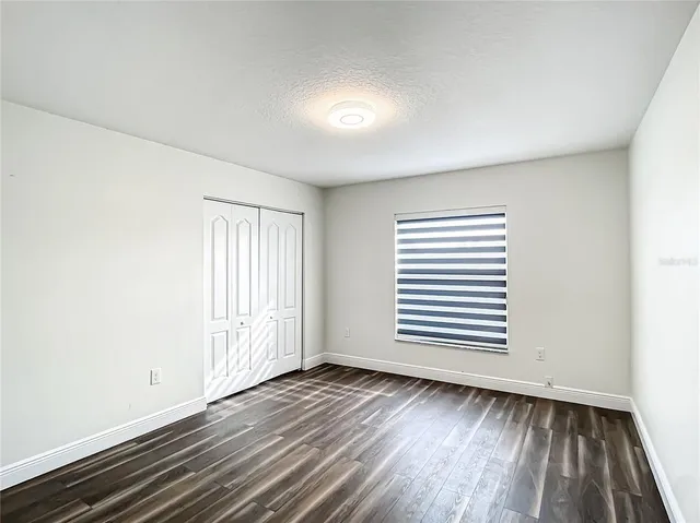 an empty room with wooden floor