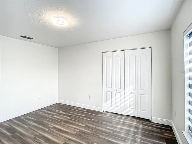 a view of an empty room and wooden floor