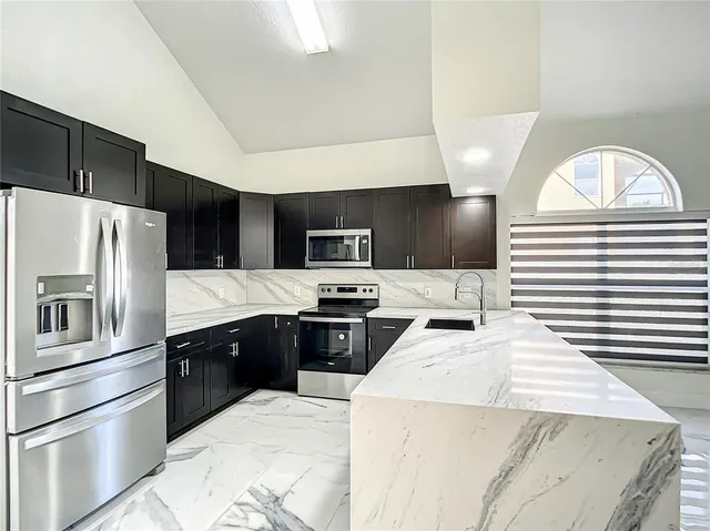 a kitchen with stainless steel appliances and white cabinets