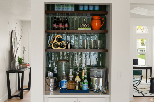 368 Spring Creek Road Providence, UT 84332 - Photo 6 of 45 Bar area featuring open shelves, light wood finished floors, white cabinets, and light countertops