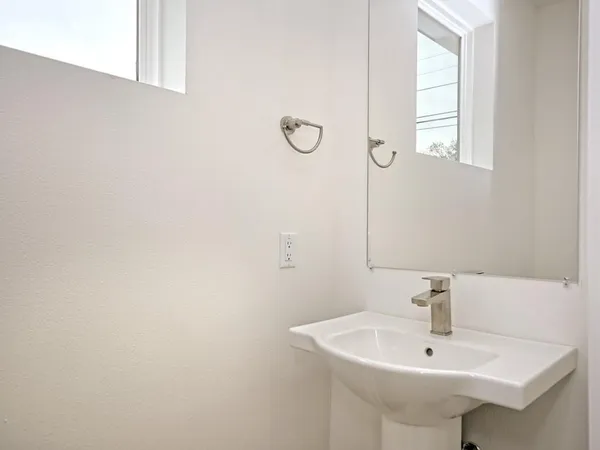 a bathroom with a sink and a window