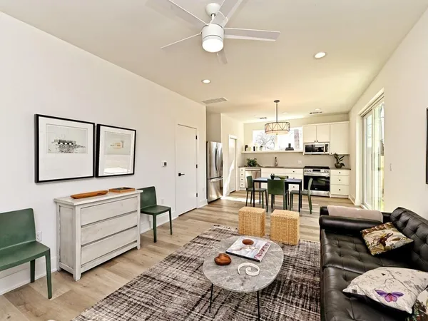 a living room with furniture and wooden floor