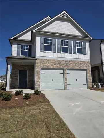 a front view of a house with garage