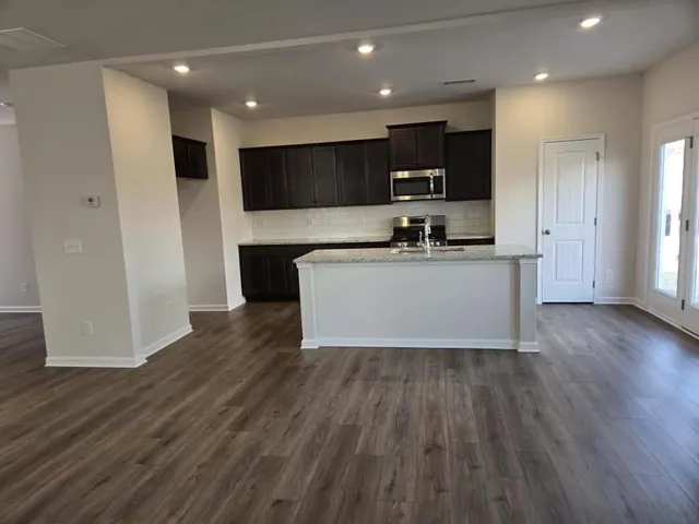 a kitchen with stainless steel appliances a refrigerator and a stove top oven