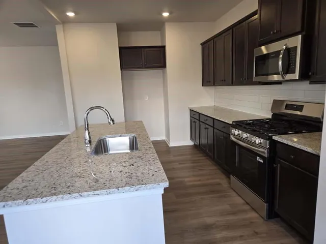 a kitchen with a stove and a microwave