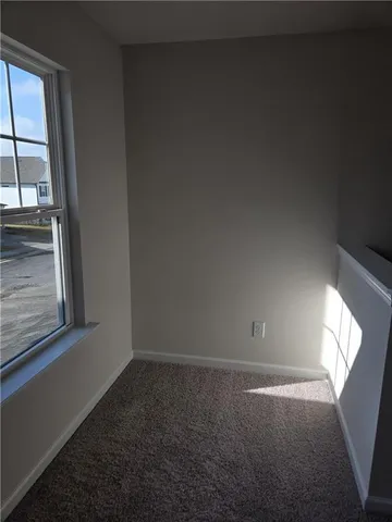 a view of an empty room with windows