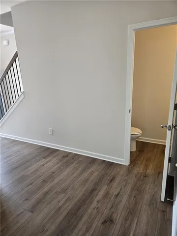 a view of a room with wooden floor and a sink