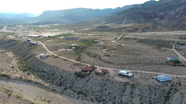 a view of a dry yard with wooden fence