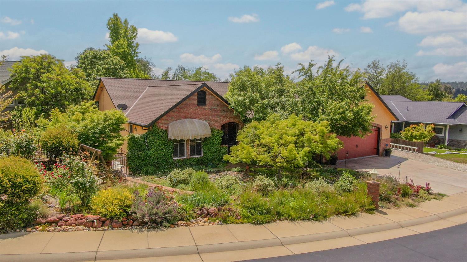 front view of a house with a yard and potted plants
