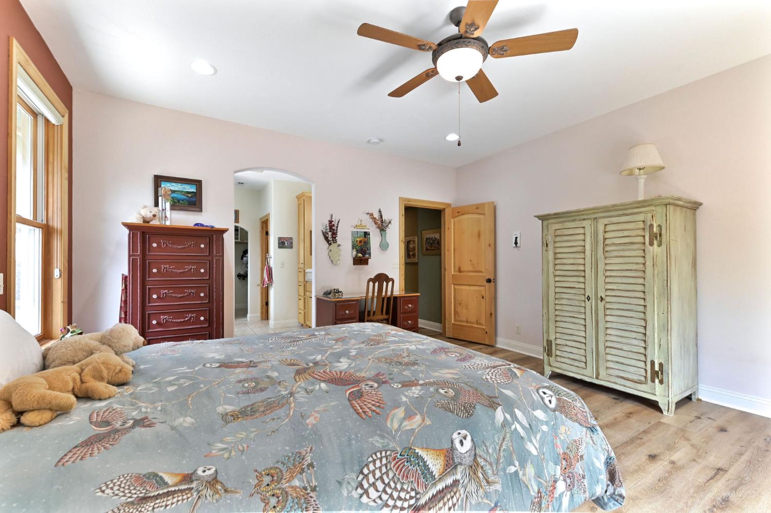 281 Oak Tree Circle Murphys, CA 95247 - Photo 21 of 96 a bedroom with a large bed and a chandelier