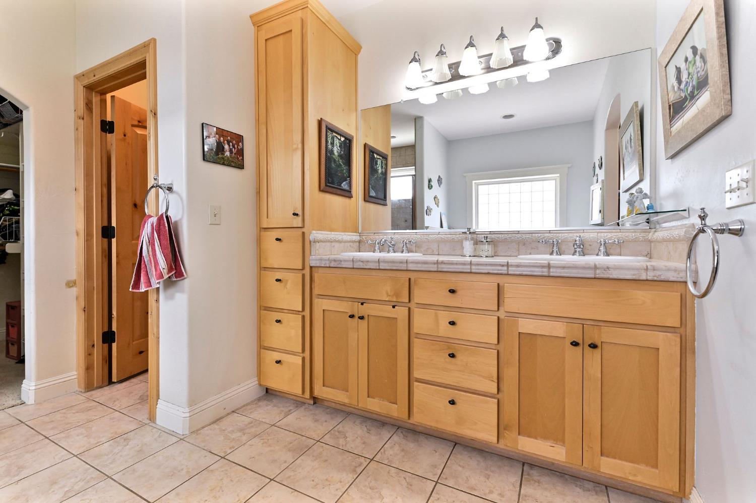 281 Oak Tree Circle Murphys, CA 95247 - Photo 24 of 96 a spacious bathroom with a granite countertop sink a mirror and a shower