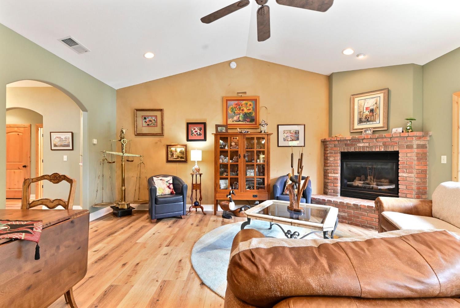 281 Oak Tree Circle Murphys, CA 95247 - Photo 34 of 96 a living room with furniture a flat screen tv and a fireplace