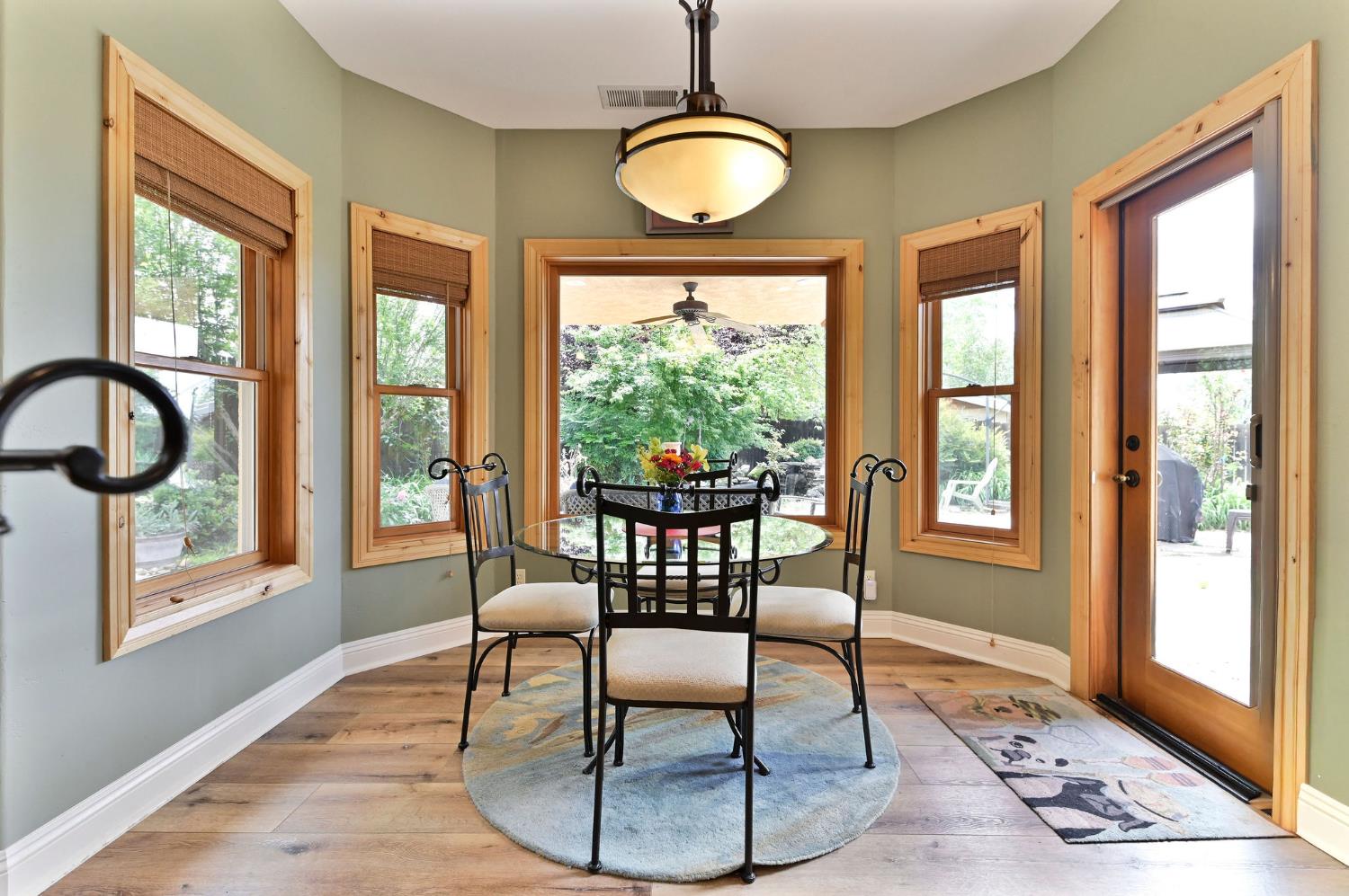 281 Oak Tree Circle Murphys, CA 95247 - Photo 41 of 96 a dining room with wooden floor and a floor to ceiling window