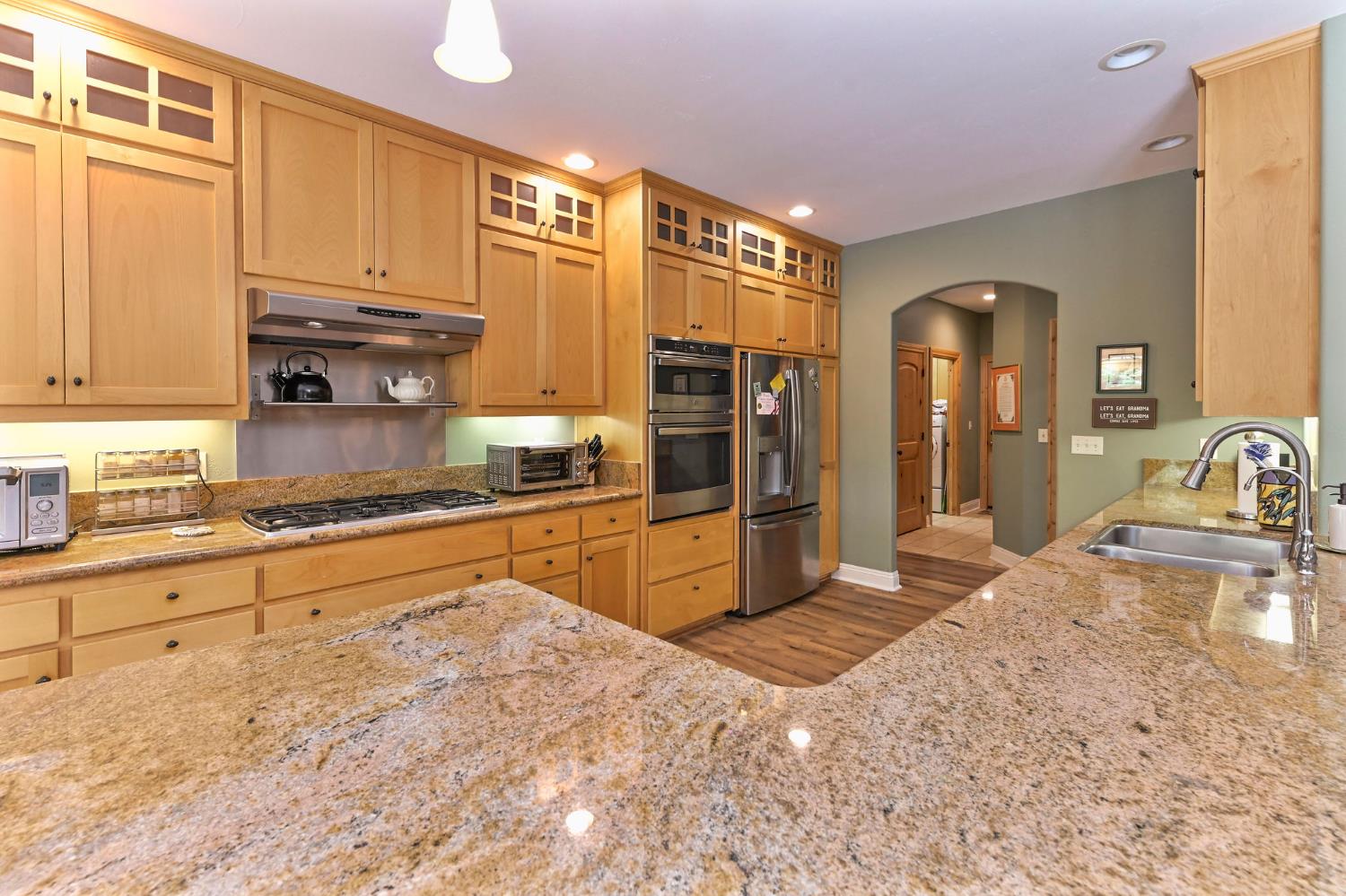 281 Oak Tree Circle Murphys, CA 95247 - Photo 43 of 96 a large kitchen with granite countertop a sink and cabinets