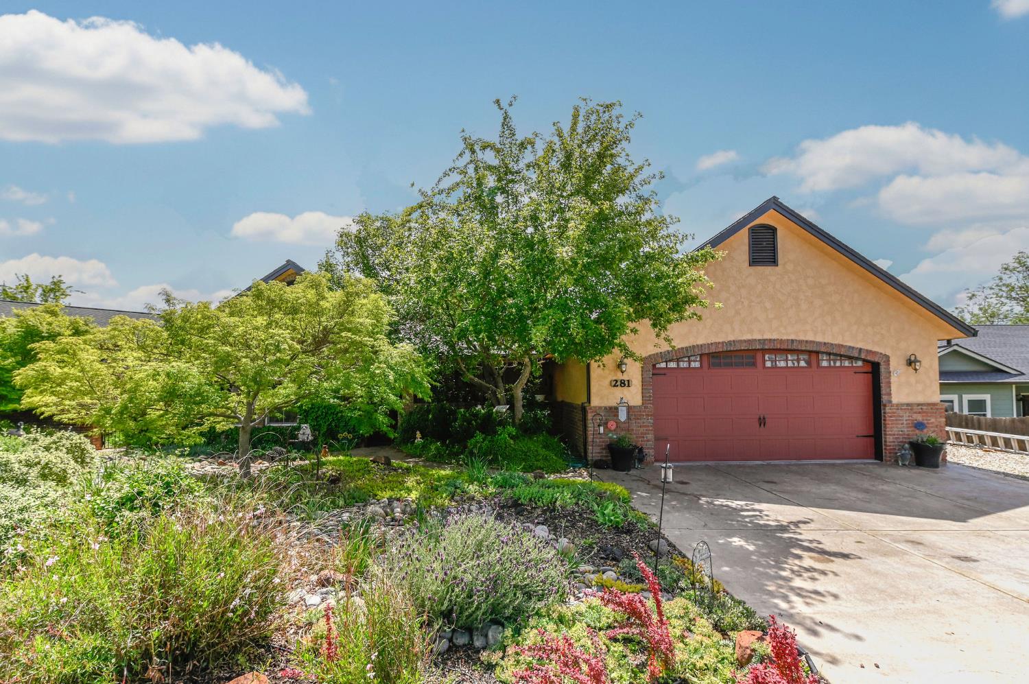 281 Oak Tree Circle Murphys, CA 95247 - Photo 54 of 96 a front view of a house with a yard and garage