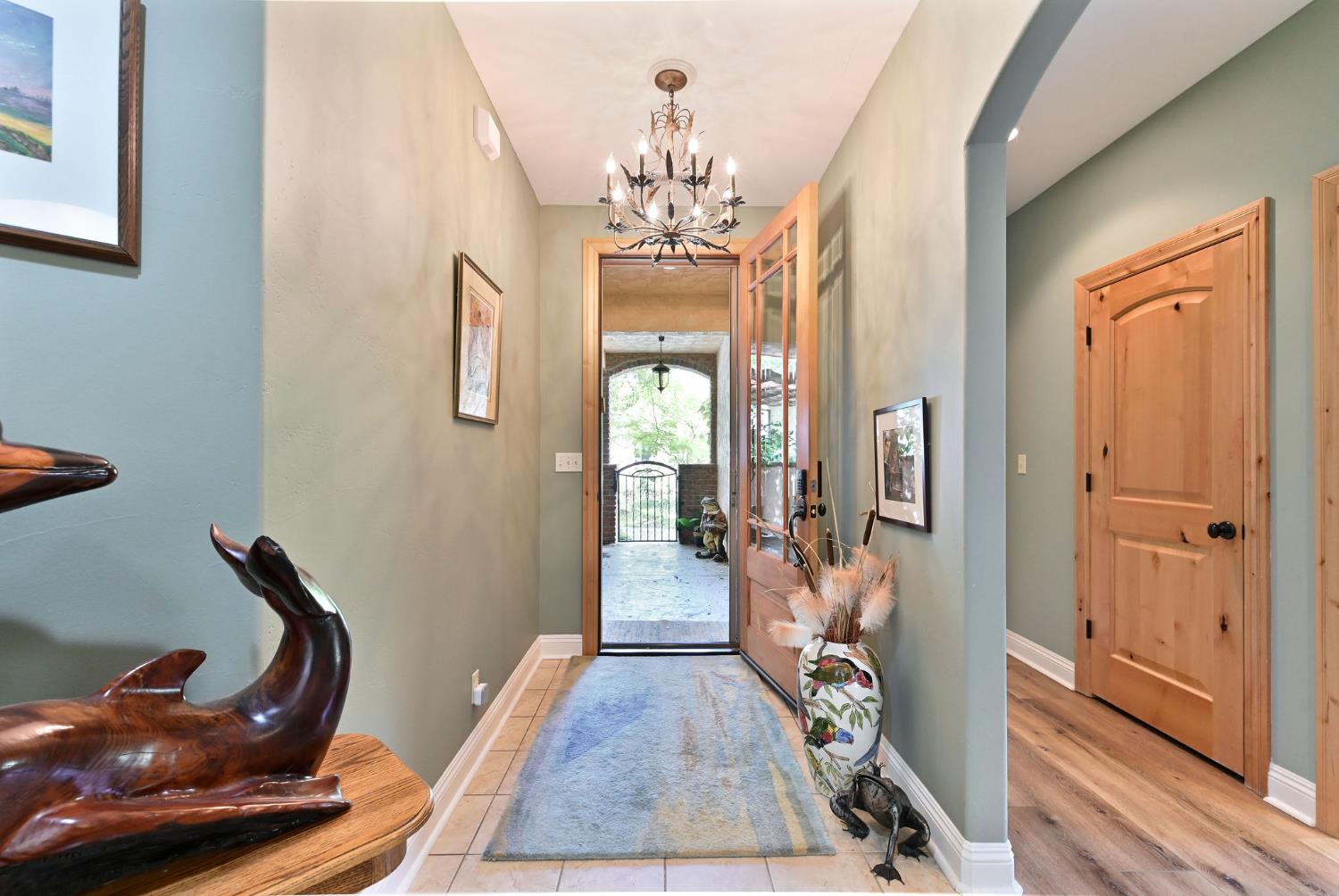 281 Oak Tree Circle Murphys, CA 95247 - Photo 8 of 96 a view of a hallway with furniture and wooden floor