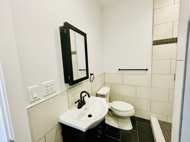 301 North Street, Unit 5 Boston, MA 02113 - Photo 14 of 18 a bathroom with a sink toilet and mirror